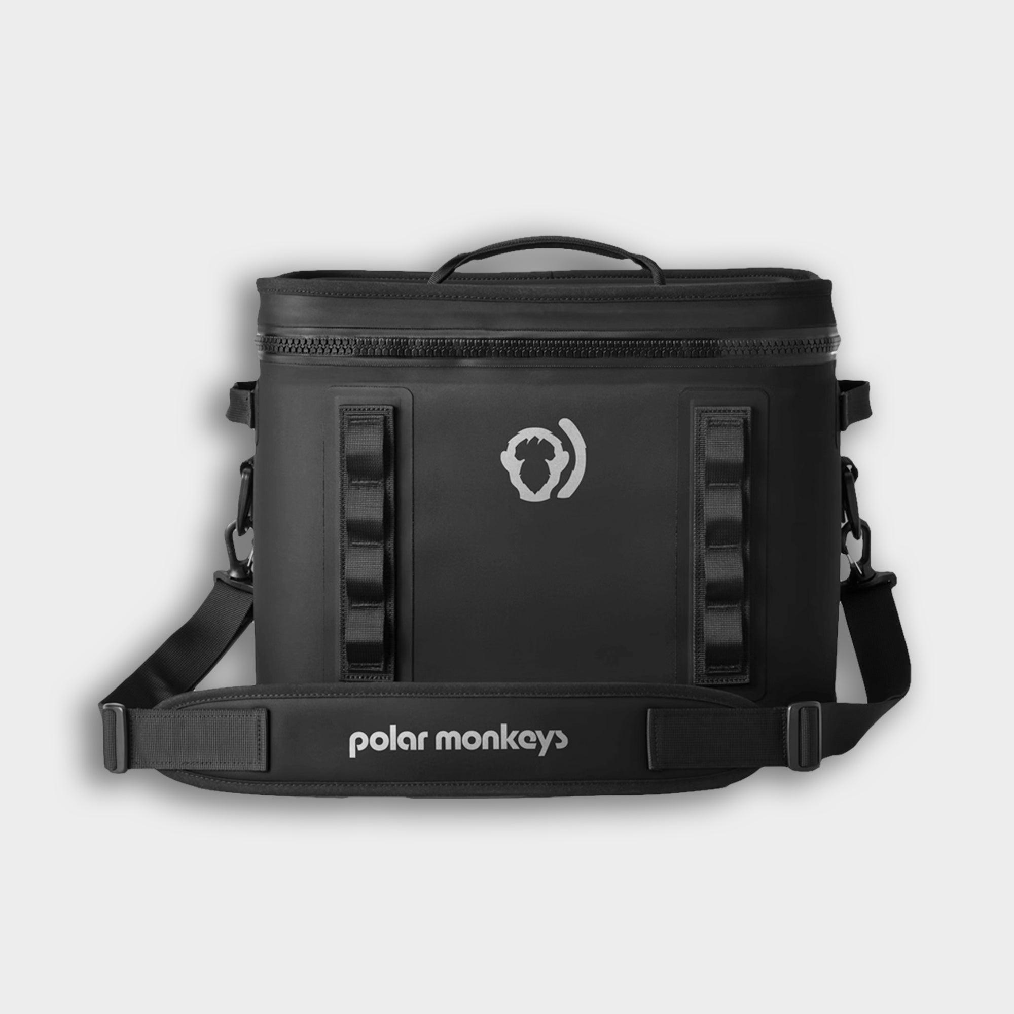 The Cave Cooler, a black soft cooler bag featuring leak-proof insulation, a handle, shoulder strap, and the Polar Monkeys logo on the front, is photographed against a plain light background.