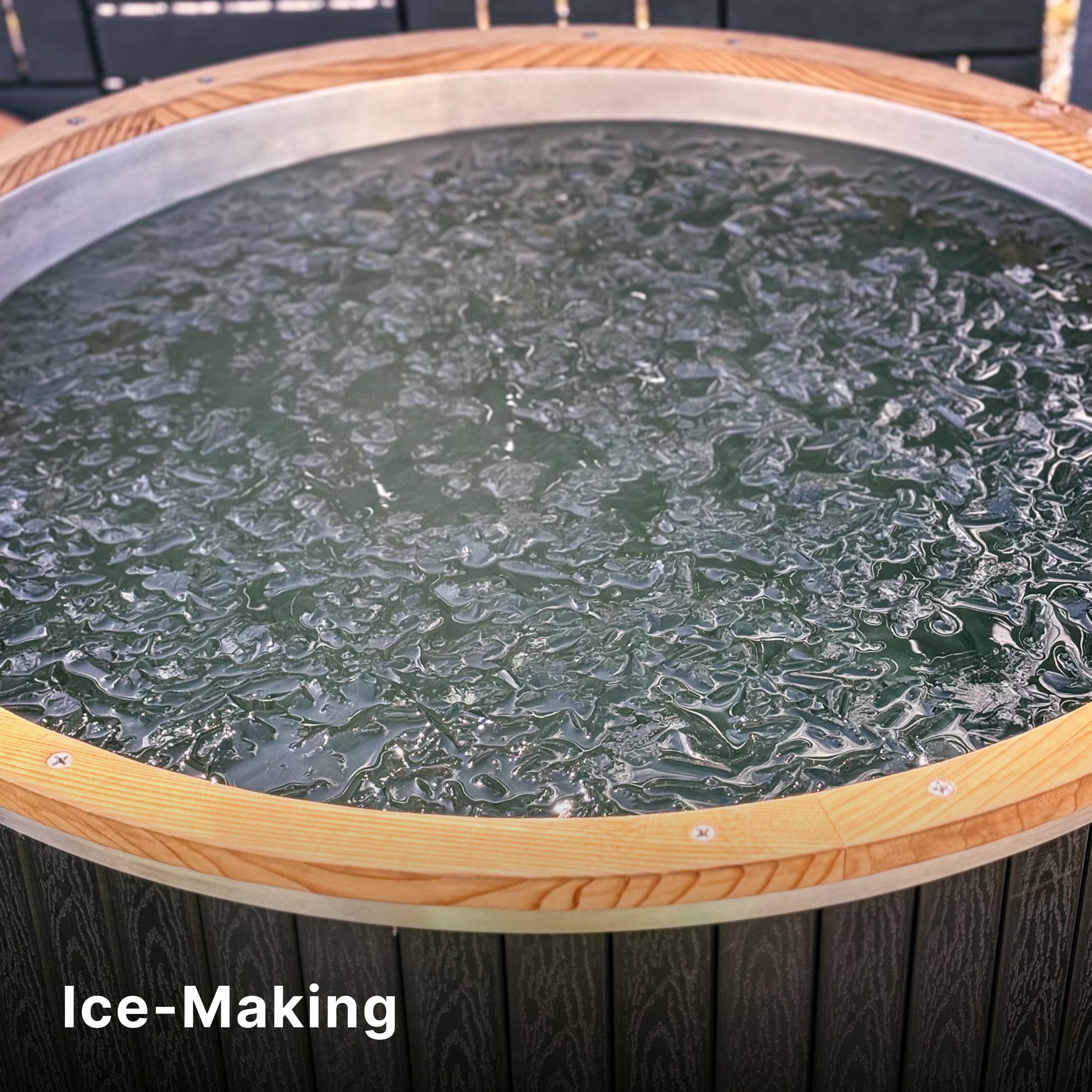 A round wooden tub filled with water beginning to freeze, with a thin layer of ice forming on the surface. The words Ice-Making appear in white text at the bottom left corner.