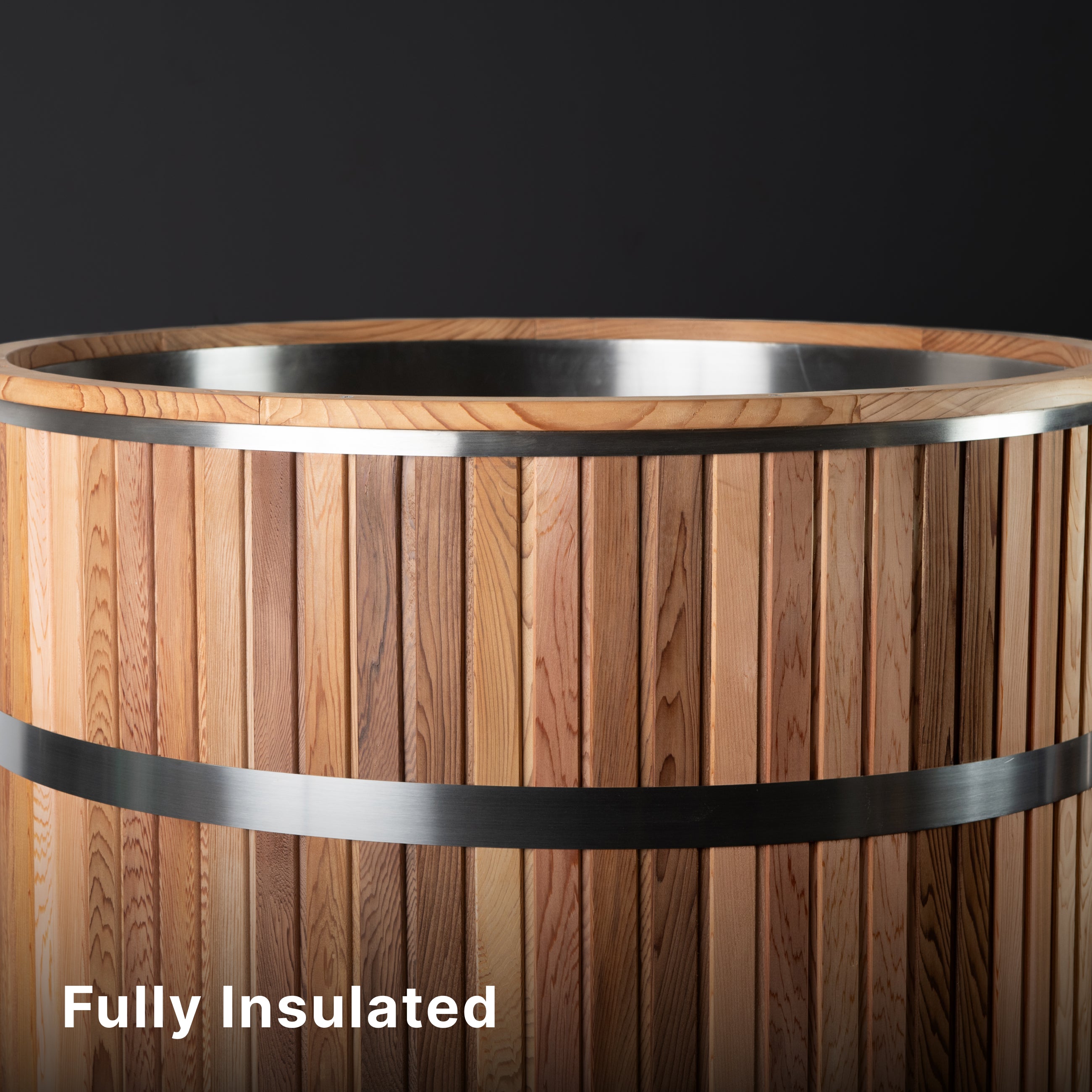 A wooden hot tub with vertical wooden slats and metal bands, shown against a dark background. The text Fully Insulated appears in the lower left corner.