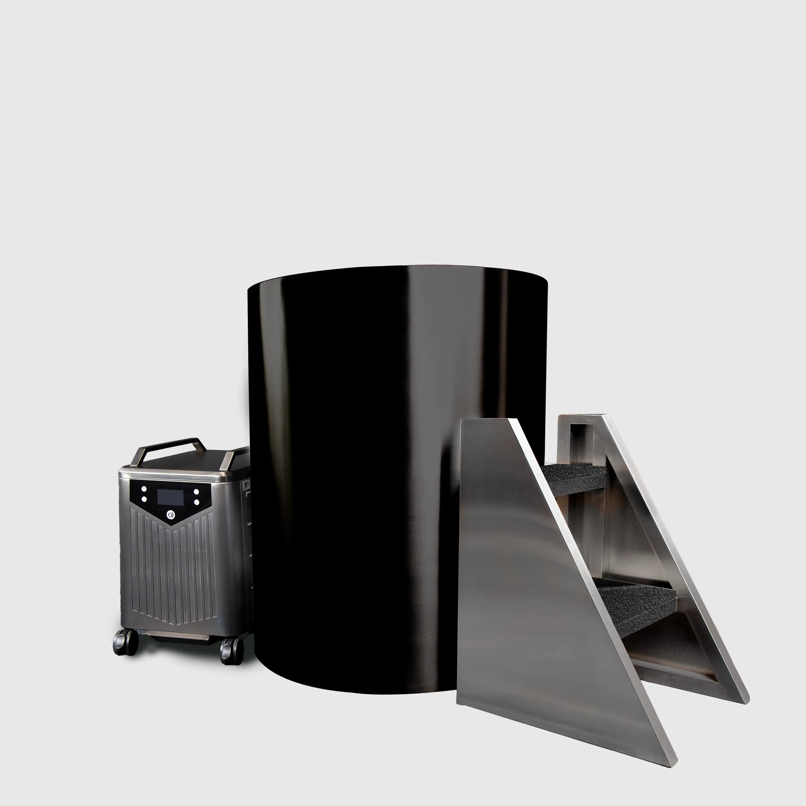 The Cyber Barrel Cold Plunge, a large glossy black vertical chamber, stands between a metallic wheeled unit on the left and a carpeted metal staircase on the right, all set against a plain light gray background.