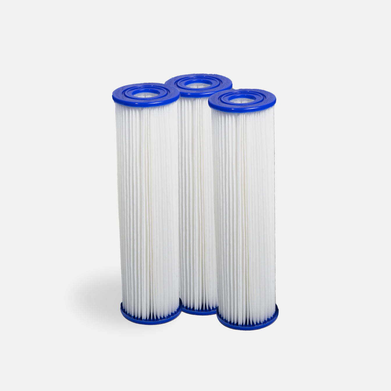 Three cylindrical white pleated filters with blue caps, designed for pro cooling power, stand side by side against a light gray background. Filter Replacement for Residential Pro Systems - 3 Pack—perfect for advanced cold plunge systems.