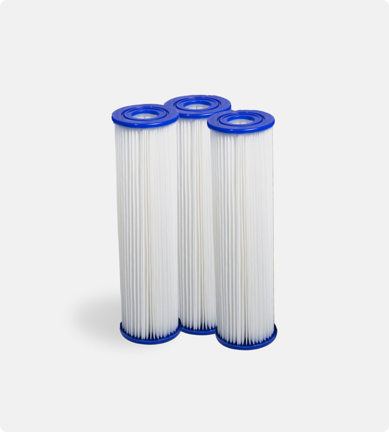 Three cylindrical white pleated filters with blue caps, designed for pro cooling power, stand side by side against a light gray background. Filter Replacement for Residential Pro Systems - 3 Pack—perfect for advanced cold plunge systems.