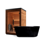 A Sauna + Brainpod 2.0 Bundle featuring a wooden home sauna with a glass door and internal heater positioned behind a black freestanding cold immersion bathtub.