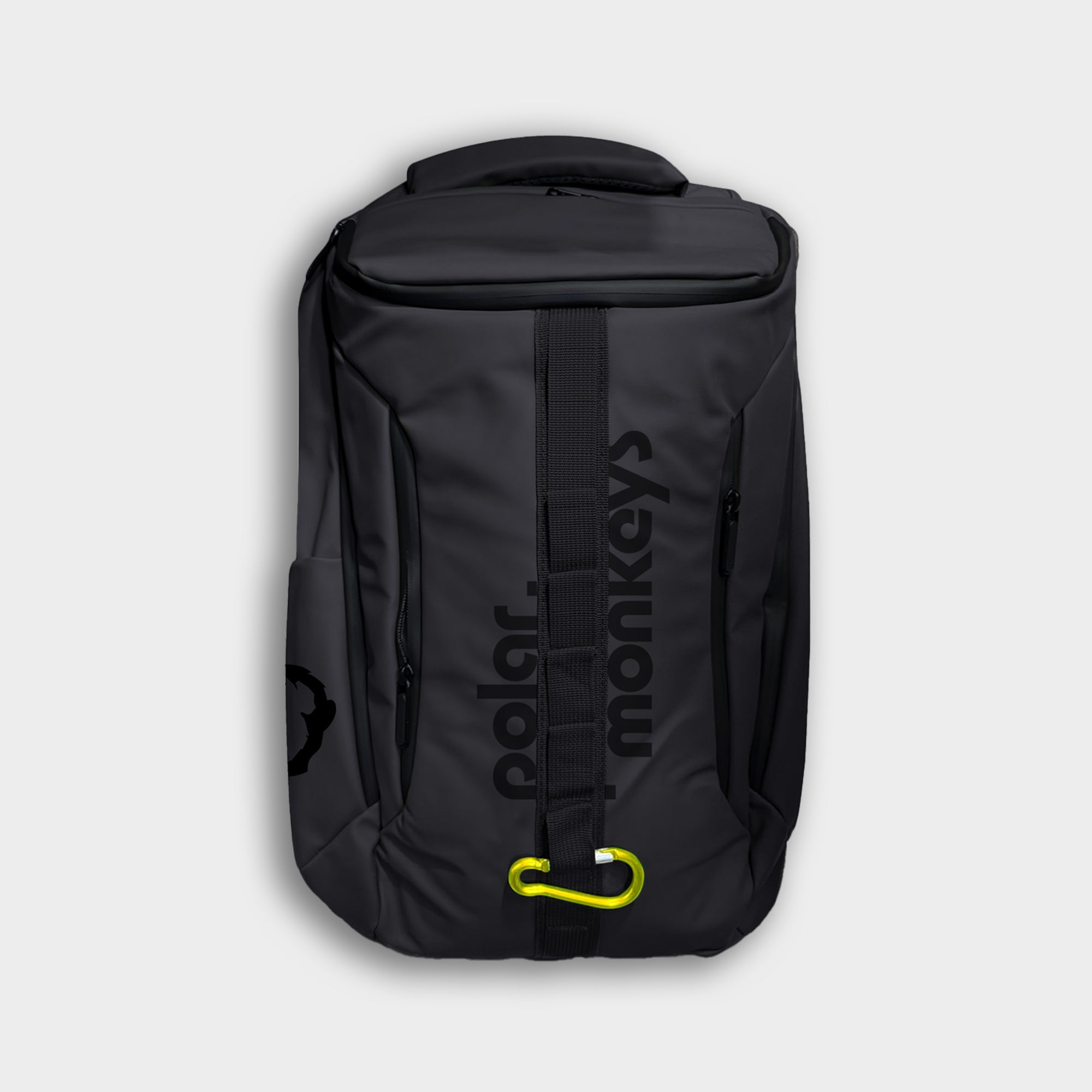 The Vault Backpack is a black everyday backpack with "polar monkeys" in dark vertical letters, a yellow carabiner on the front strap, shown against a light gray background.