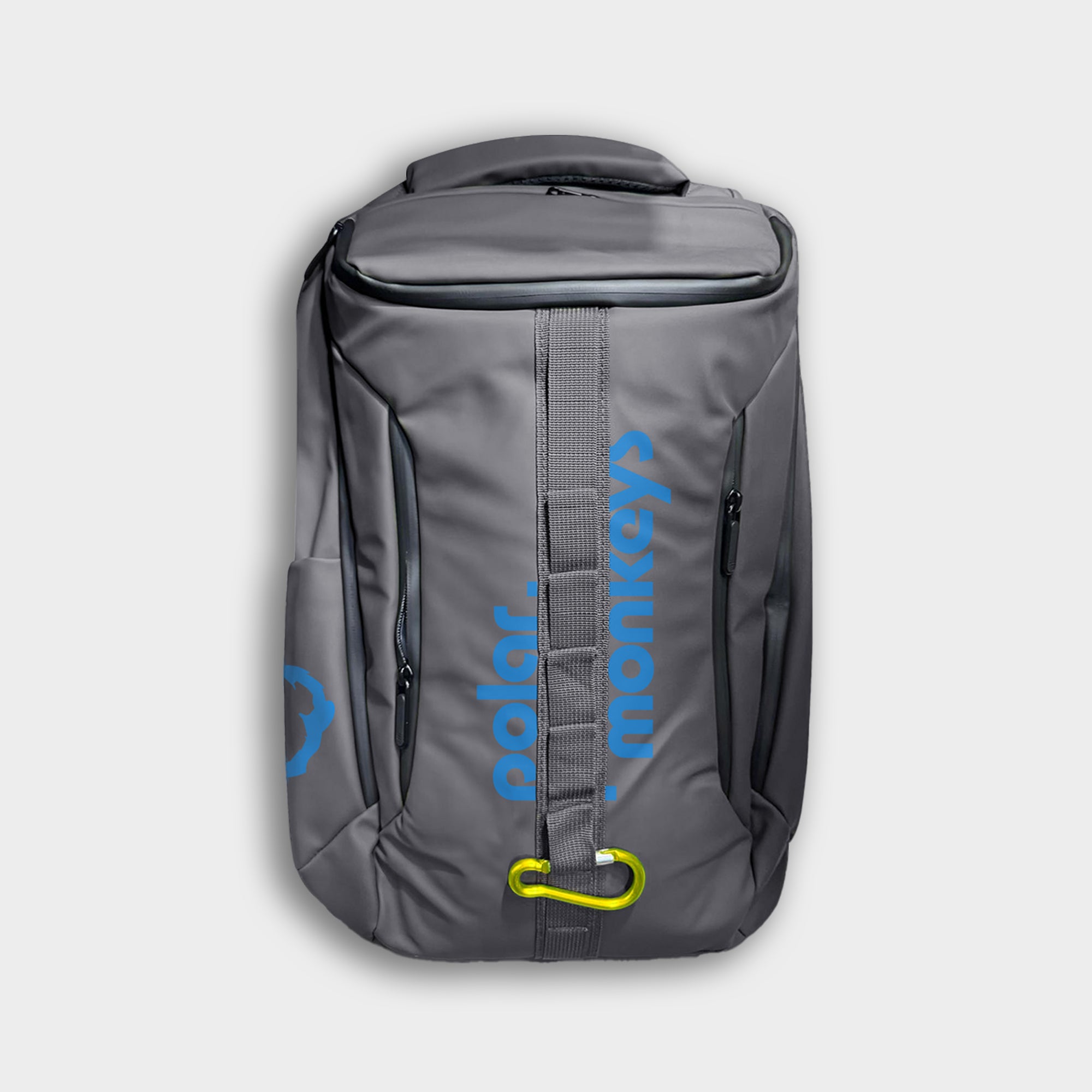 The Vault Backpack is a sleek gray all-weather bag with "polar monkeys" in blue vertically on the front, multiple zippers, a top handle, and a yellow carabiner attached to the front strap.