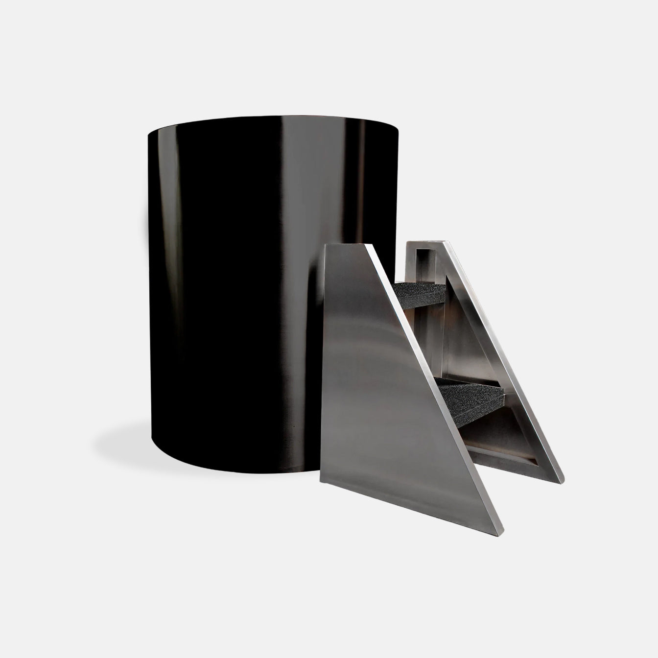The Cyber Barrel Commercial Cold Plunge, a sleek black cylindrical unit, is displayed beside a modern stainless steel triangular staircase with three carpeted steps, all set against a plain white background.
