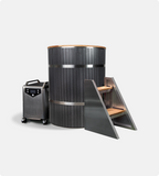 The Star Treatment 2.0 Cold Plunge is a modern cylindrical tub with an integrated seat, dark paneling, metal and wood steps, and a sleek portable chiller on wheels—all thoughtfully designed to fit compact spaces against a plain white background.