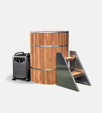 The Star Treatment 2.0 Cold Plunge is a cylindrical wooden tub with metal bands, an integrated seat, black wheeled control unit, and metal stairs—set on a plain white background, making it ideal for compact spaces.