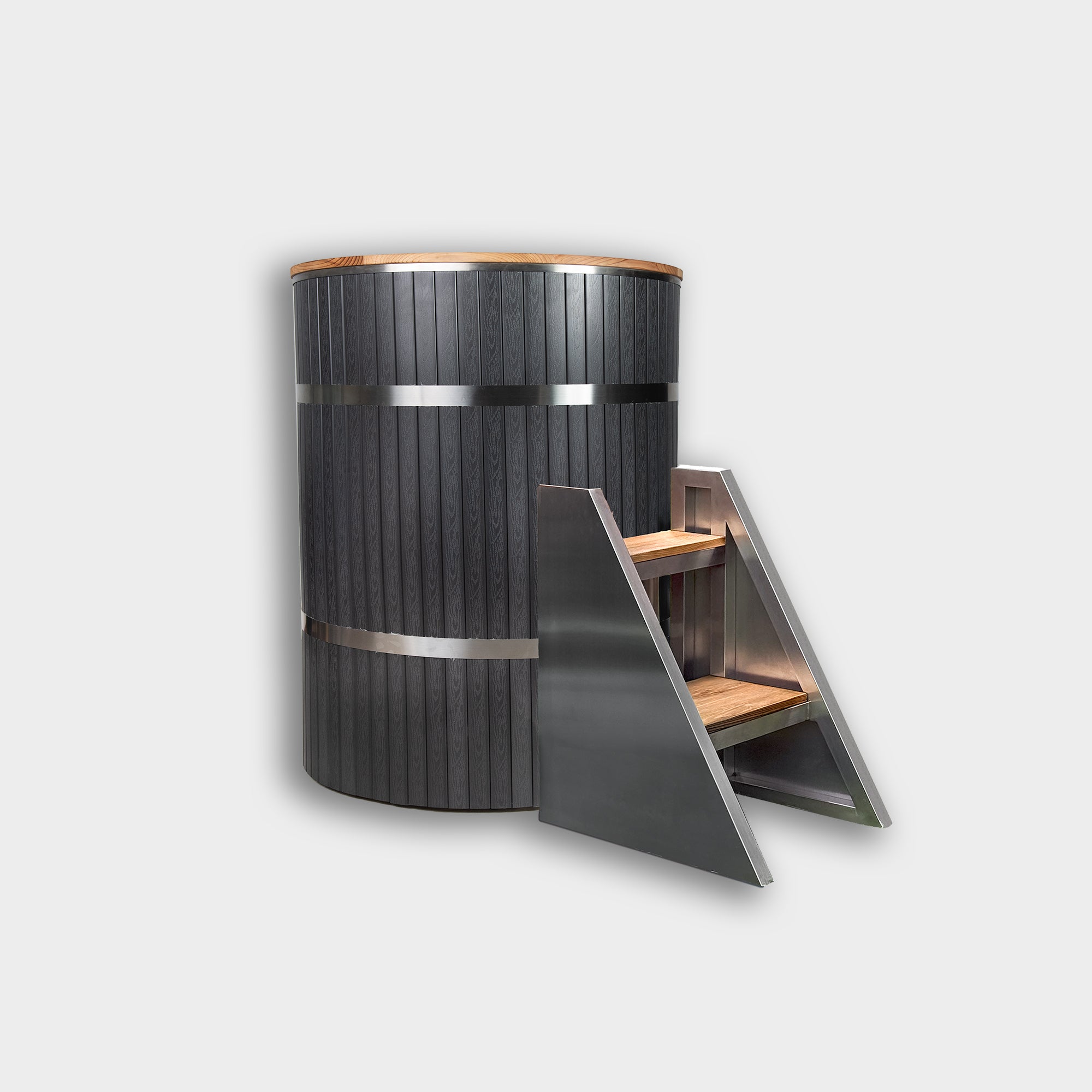 The Star Treatment 2.0 Commercial Cold Plunge is a tall, cylindrical wooden tub with metal bands for cold therapy, paired with angled wood and metal steps for easy access. Set against a plain, light gray background.