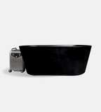 The Brainpod 2.0 Cold Plunge, a sleek modern black acrylic bathtub, is displayed beside a wheeled silver suitcase, both set against a plain light gray background.