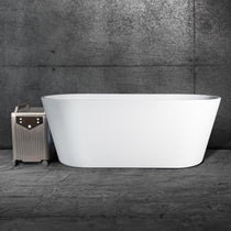 The Brainpod 2.0 Cold Plunge, a modern white acrylic bathtub, sits on a concrete floor beside a metallic portable appliance on wheels, set against a dark textured wall.