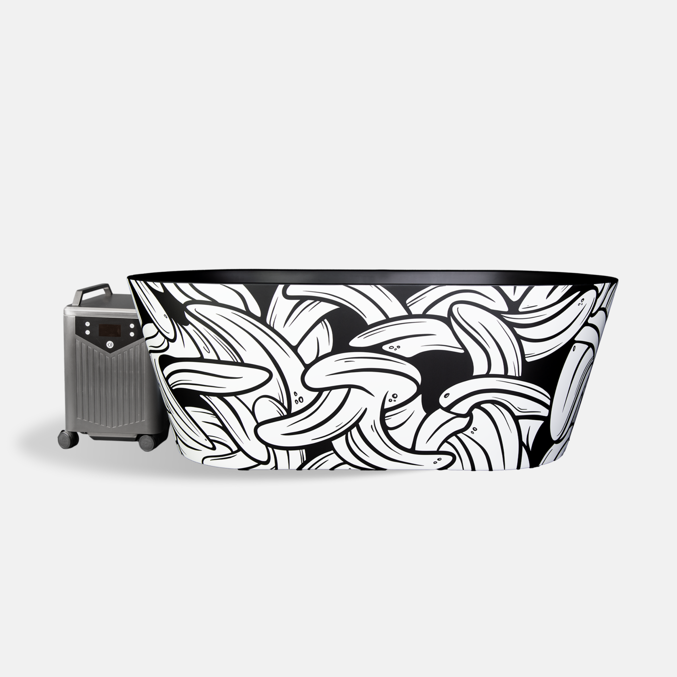 The Brainpod 2.0 Cold Plunge, an artist-designed freestanding black and white tub featuring a bold banana pattern, stands next to a compact metallic portable heater with wheels, set against a plain light background.