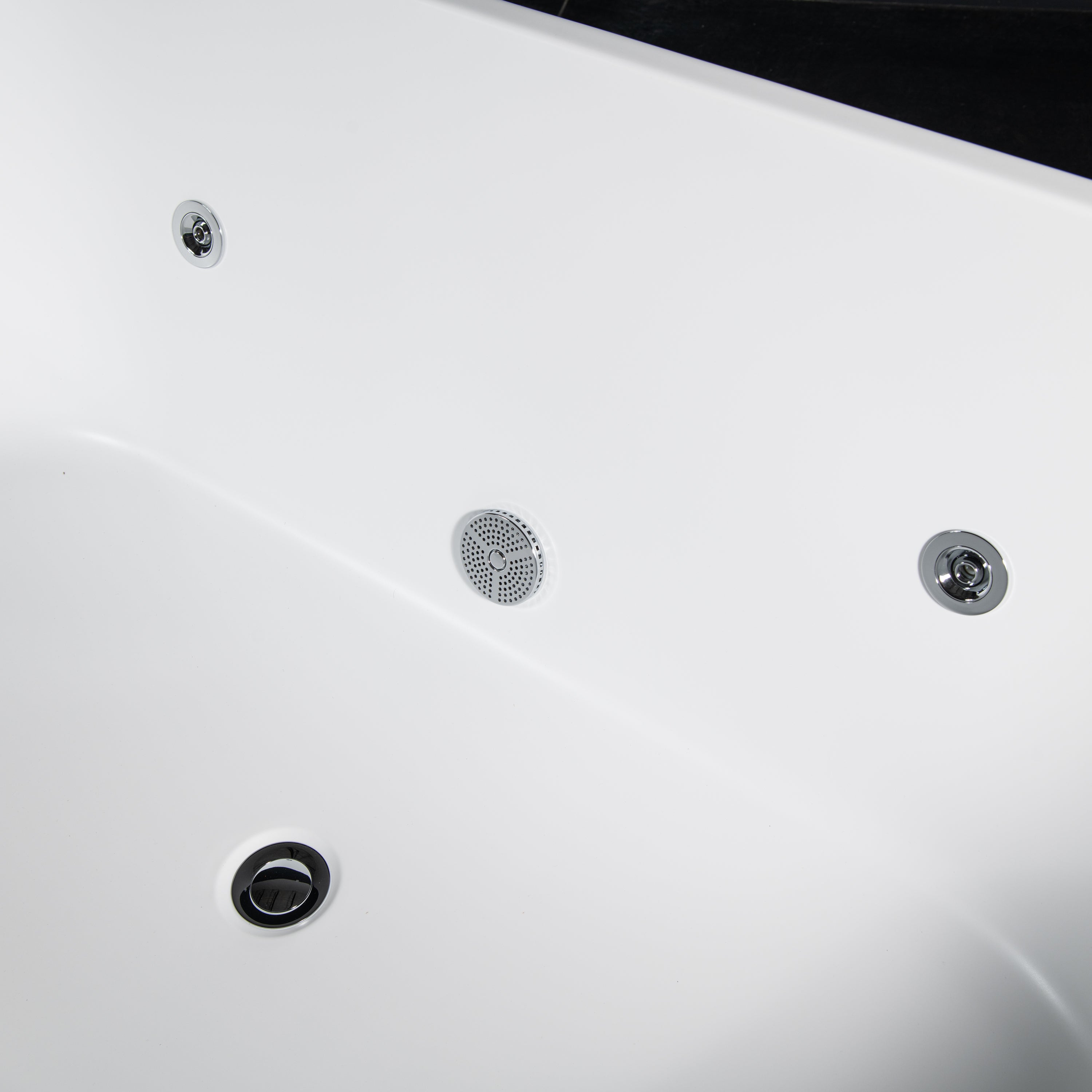 Close-up of the Brainpod 2.0 Commercial Cold Plunges white acrylic interior, showing three metallic jets, a circular mesh drain or speaker, and part of the tub edge; its clean, smooth surface highlights ergonomic design.