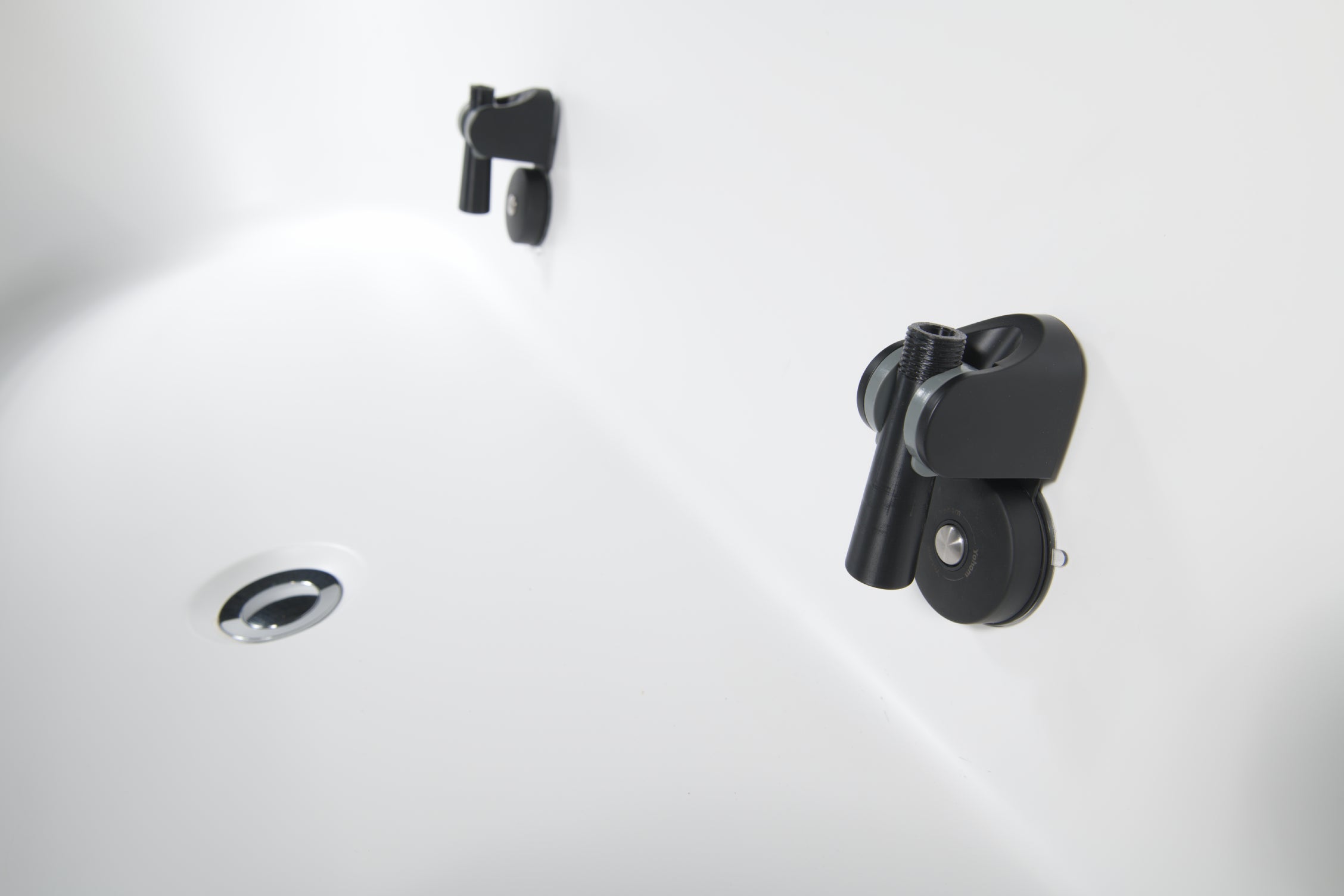 Close-up of the Brainpod 2.0 Cold Plunge, a white tub with a chrome drain and two black ergonomic rollers attached to the wall, designed for enhanced comfort and modern style.