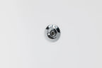 A close-up of the Brainpod 2.0 Cold Plunge, showcasing its circular, chrome-plated, ergonomic design mounted against a smooth white surface.