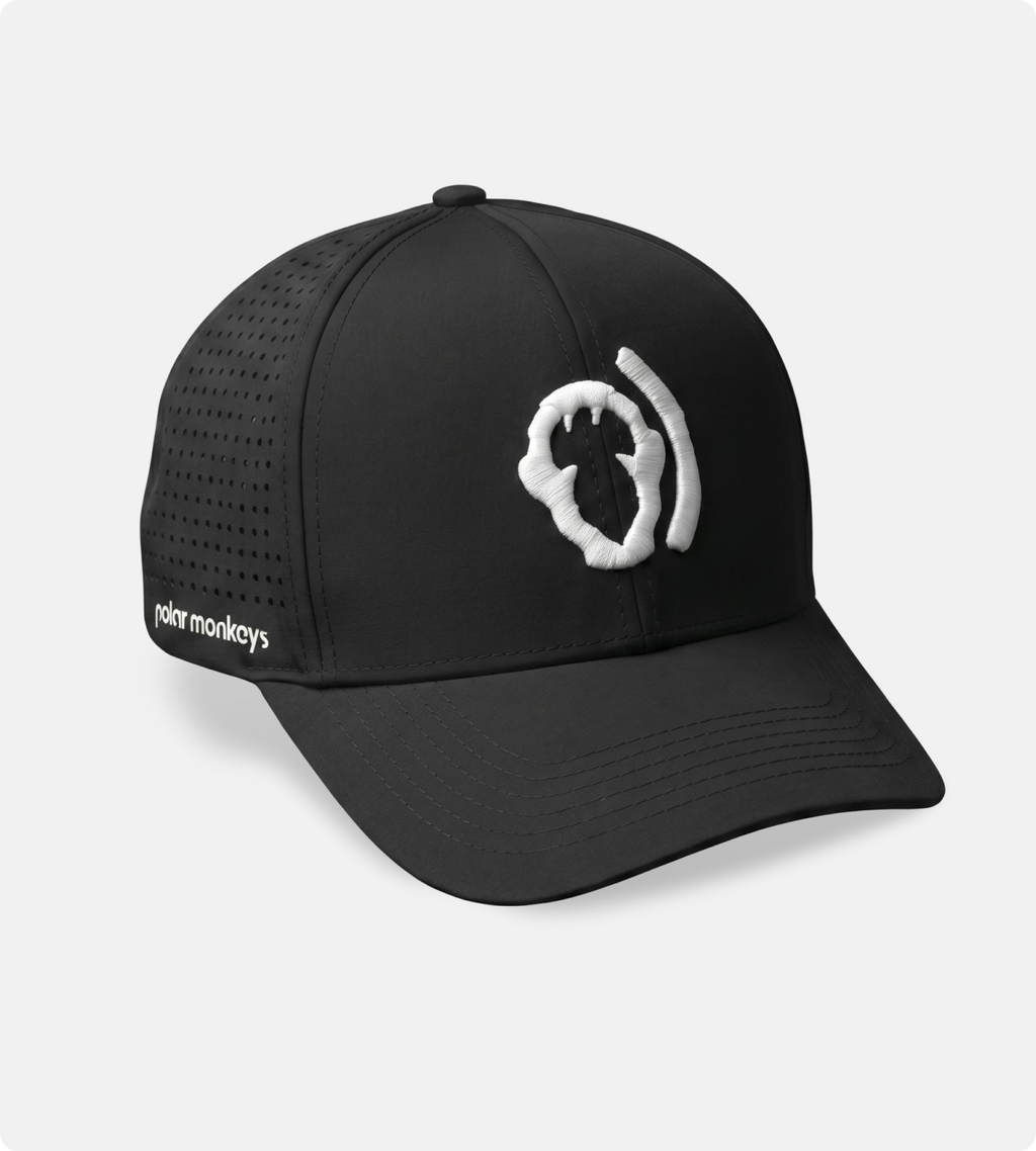 The Polar Monkeys Cap is black with mesh side panels for breathability, a white abstract logo on the front, and "rohr monkeys" embroidered in white on the side.