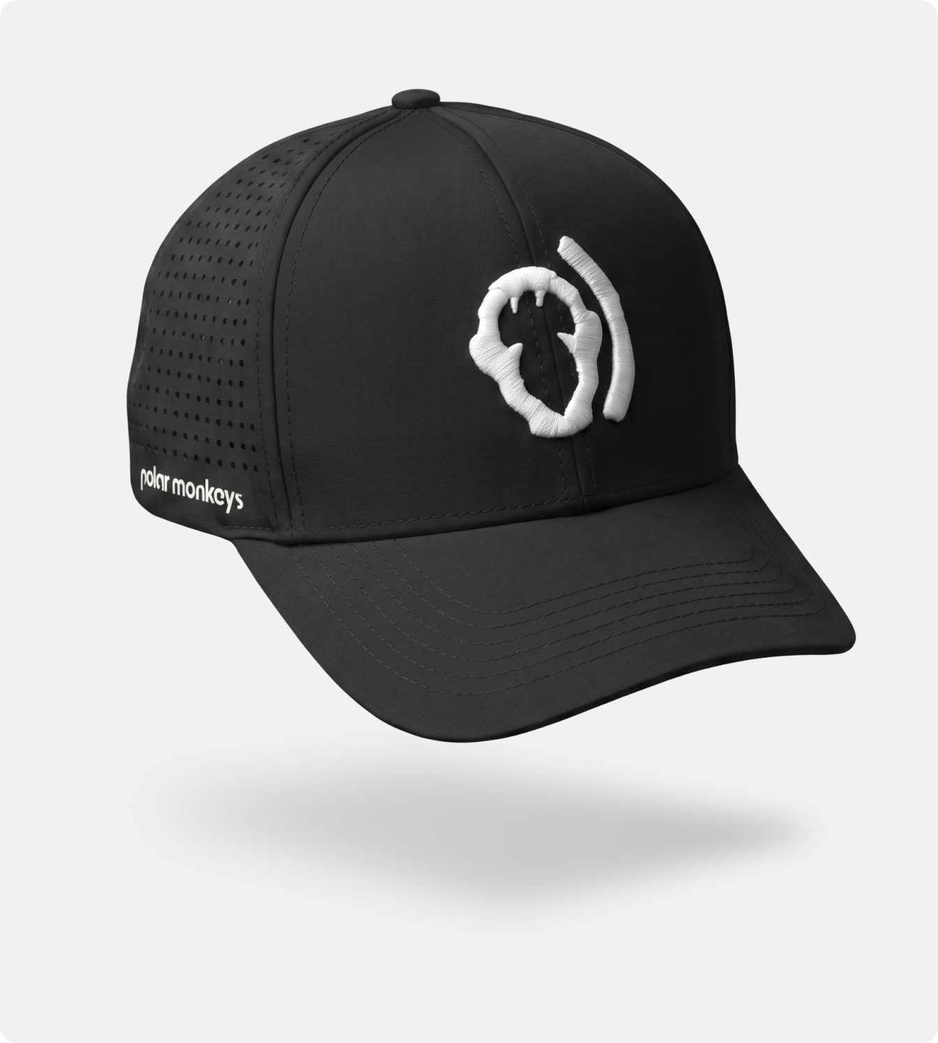 A black Polar Monkeys Cap with a white abstract front logo, breathable perforated side panels, and "rohr monkeys" text on the left, shown floating against a plain white background.