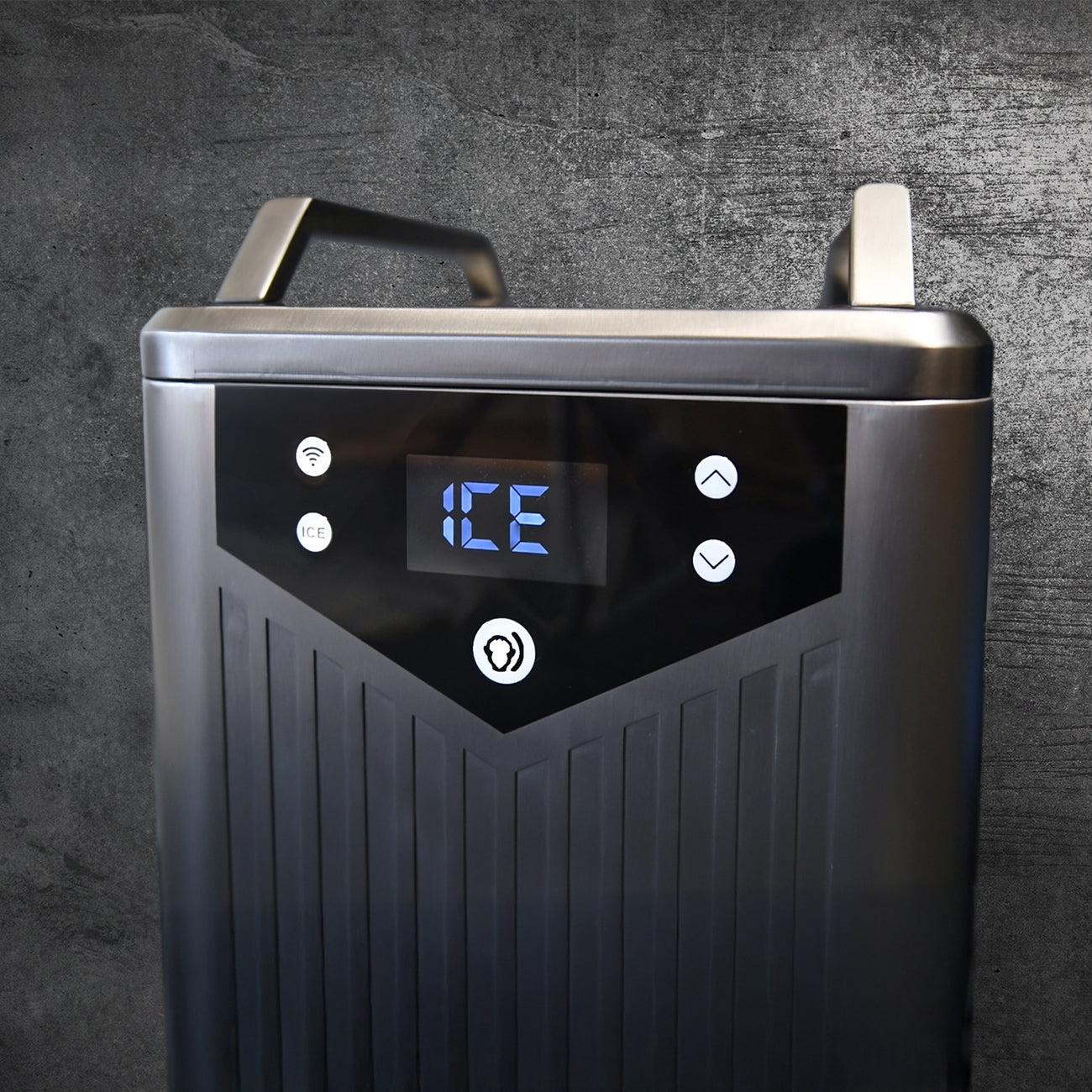 Close-up of the Cyber Barrel, a modern black ice maker with marine-grade stainless steel, a blue digital display showing ICE, easy-access buttons, and a textured front panel set against a dark textured background.