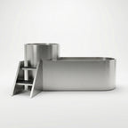 The Contrast Edition is a modern stainless steel bathtub with a cylindrical section and built-in steps, designed for hot and cold therapy, shown against a plain white background.