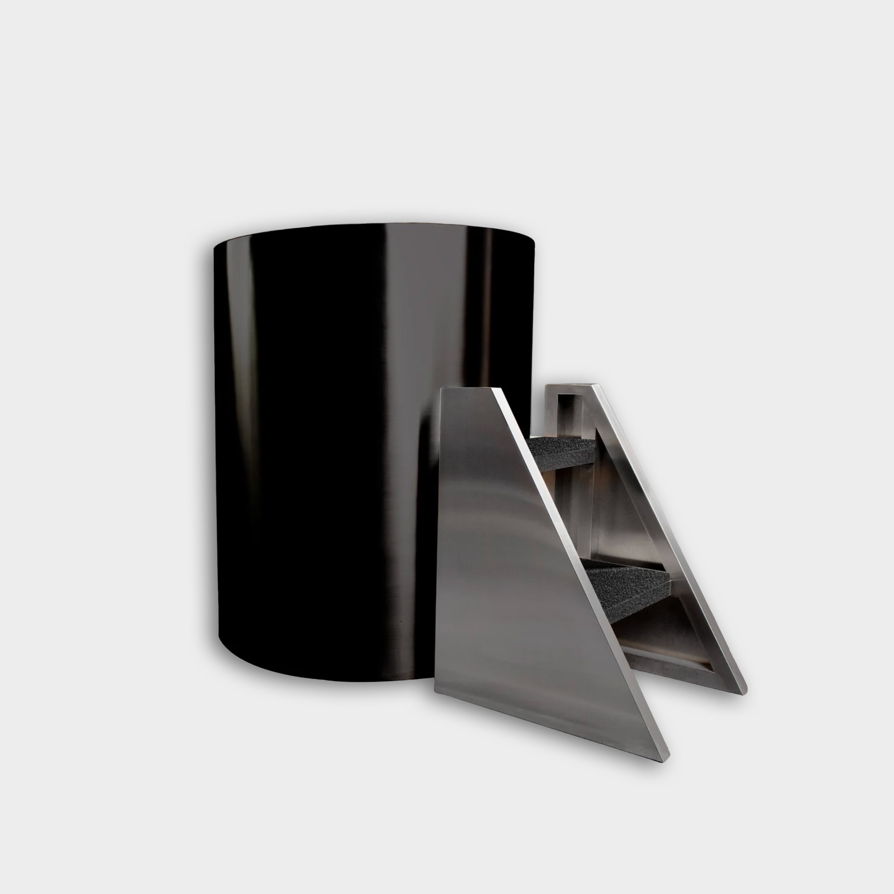The Cyber Barrel Commercial Cold Plunge, a sleek black cylindrical unit, is displayed beside a modern stainless steel triangular staircase with three carpeted steps, all set against a plain white background.