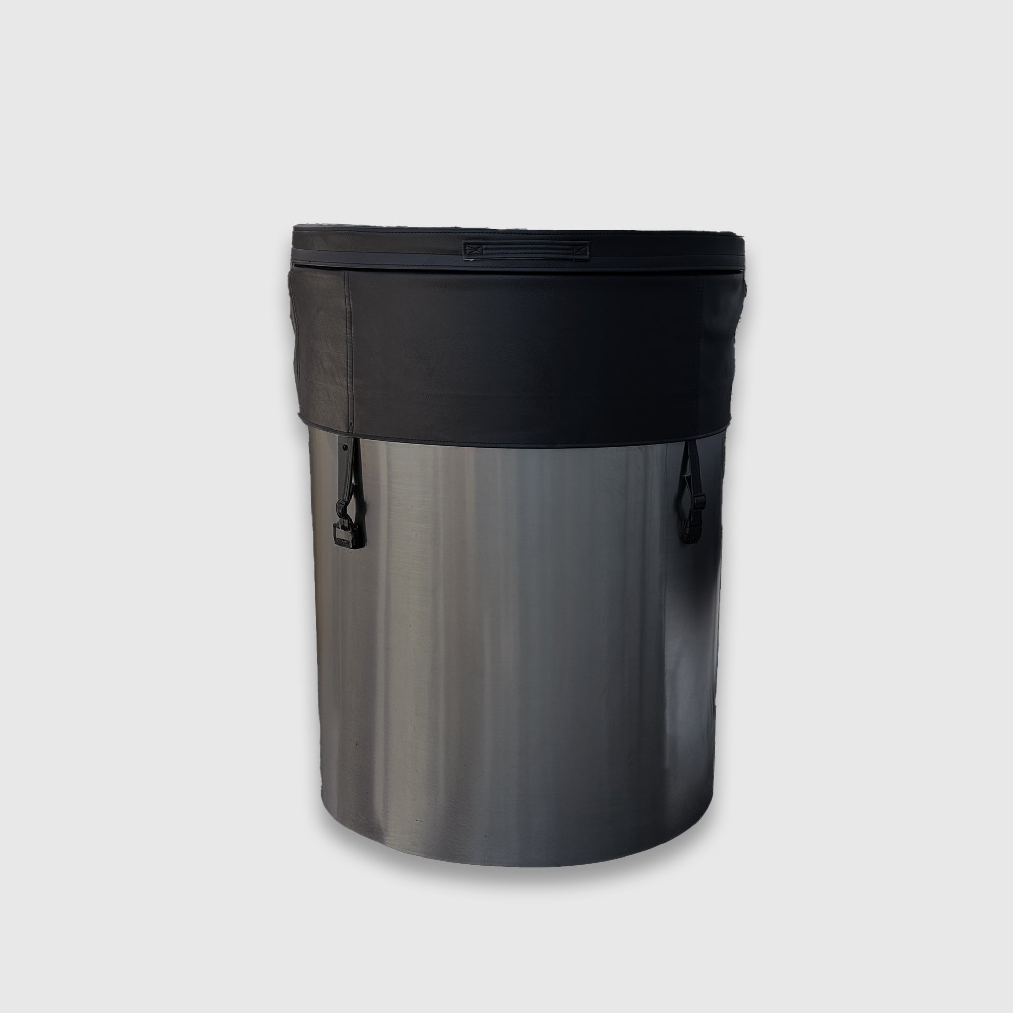 A stainless steel cylindrical container featuring the Insulated Cold Plunge Cover in black and two side handles, set on a plain light gray background.