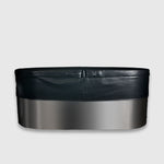 The Insulated Cold Plunge Cover features a modern oval design with a smooth metallic lower section, black upper rim, and marine-grade synthetic leather details, shown against a plain light gray background.