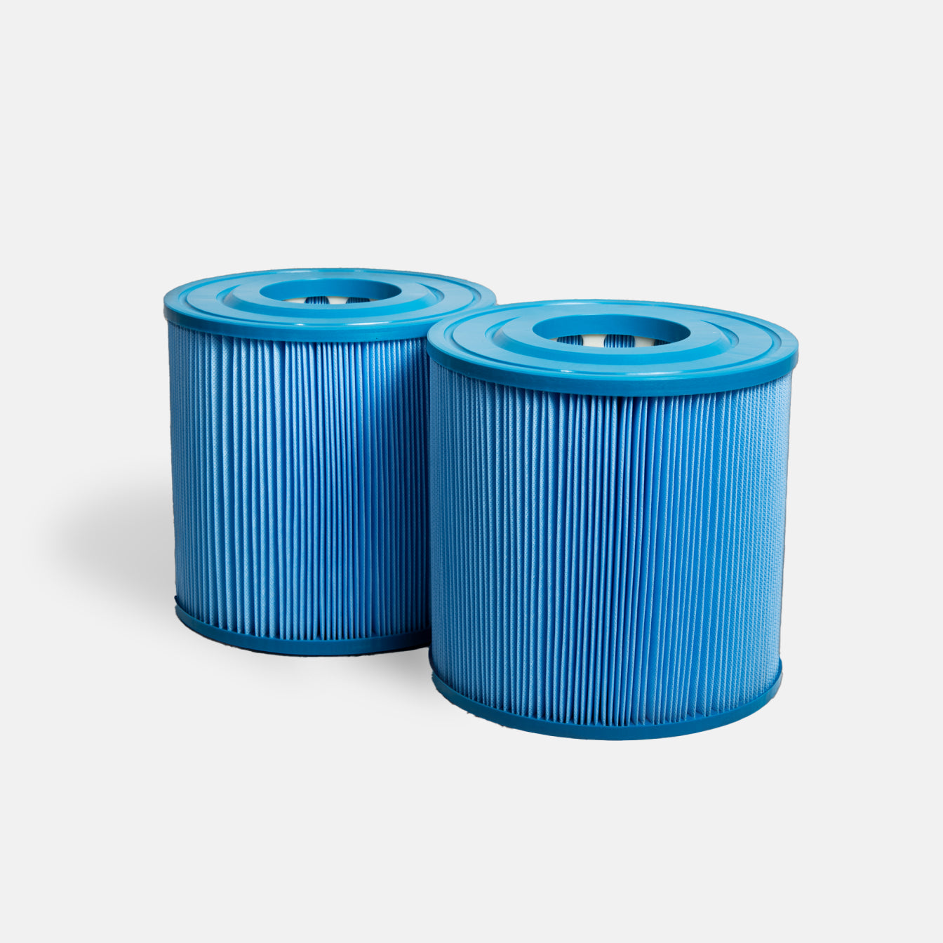 Two cylindrical blue Filter Replacement for Commercial Systems with pleated sides stand side by side on a light gray background—a perfect choice as pool or spa filter replacements for commercial cold plunge systems.