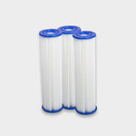 Three cylindrical white pleated filters with blue caps, designed for pro cooling power, stand side by side against a light gray background. Filter Replacement for Residential Pro Systems - 3 Pack—perfect for advanced cold plunge systems.