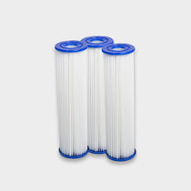 Three cylindrical white pleated filters with blue caps, designed for pro cooling power, stand side by side against a light gray background. Filter Replacement for Residential Pro Systems - 3 Pack—perfect for advanced cold plunge systems.