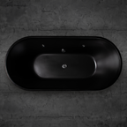 A top-down view of the Brainpod 2.0 Commercial Cold Plunge—a sleek black oval tub with ergonomic design—set against a dark gray stone wall. Its minimalist style and smooth finish give it a modern, luxurious look.