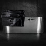 The Insulated Cold Plunge Cover, crafted from marine-grade synthetic leather, fits over a modern stainless steel tub set against a dark textured background. The Polar Monkeys logo appears on the side of the tub.