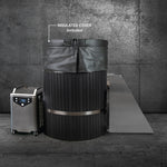 The Star Treatment 2.0, a premium black cold plunge tub with an insulated cover and chiller display, fits compact spaces. A metal ramp leads to the tub, all set against a stylish dark industrial backdrop.